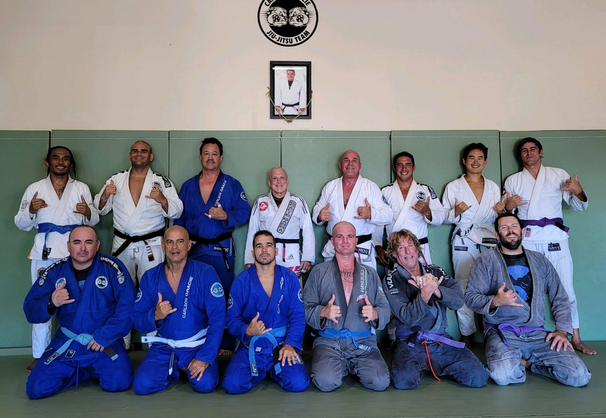 Adult students in their gis on the mats at the academy