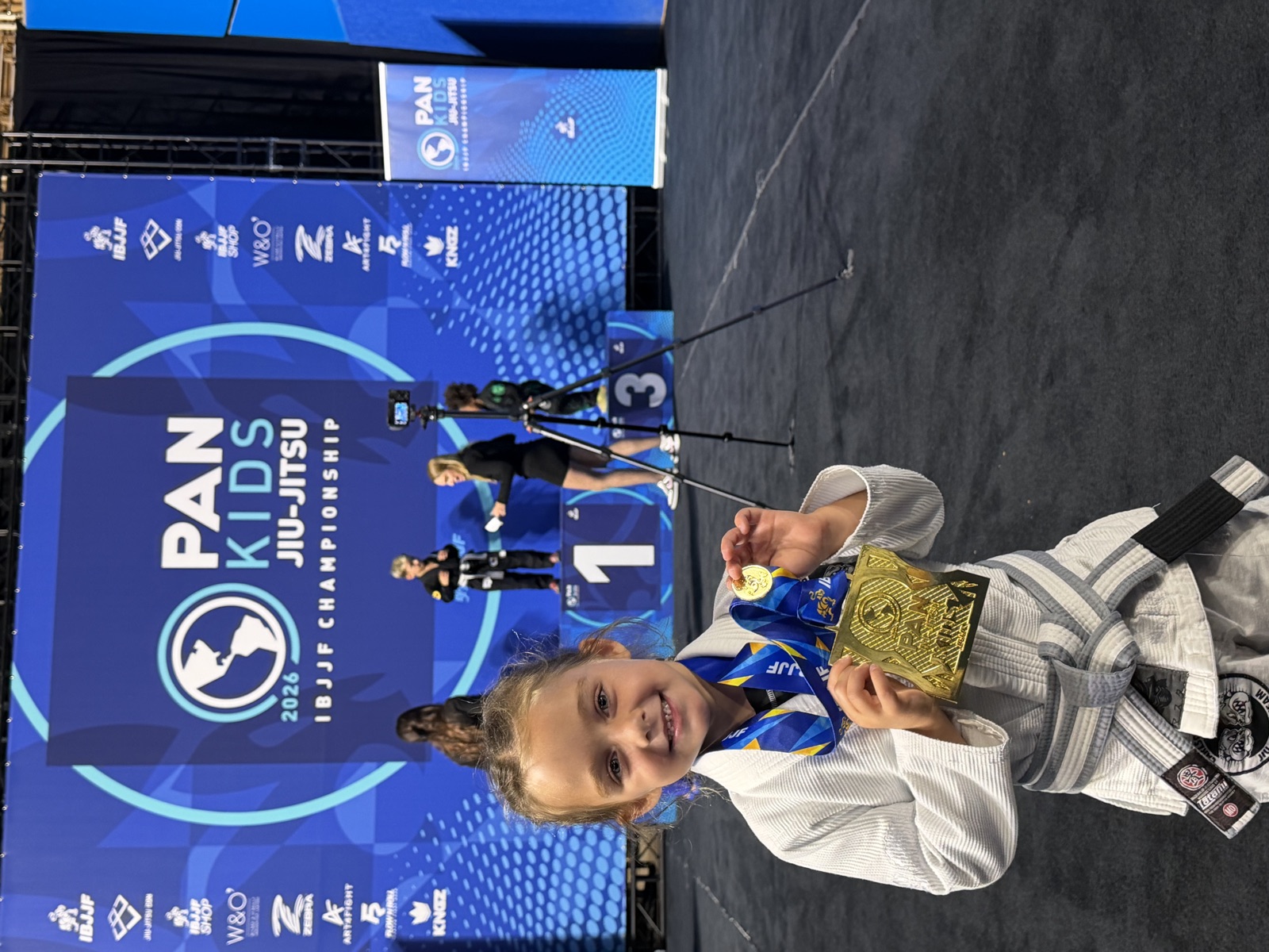 A young student with her gold medal at the IBJJF Pan Kids Championship